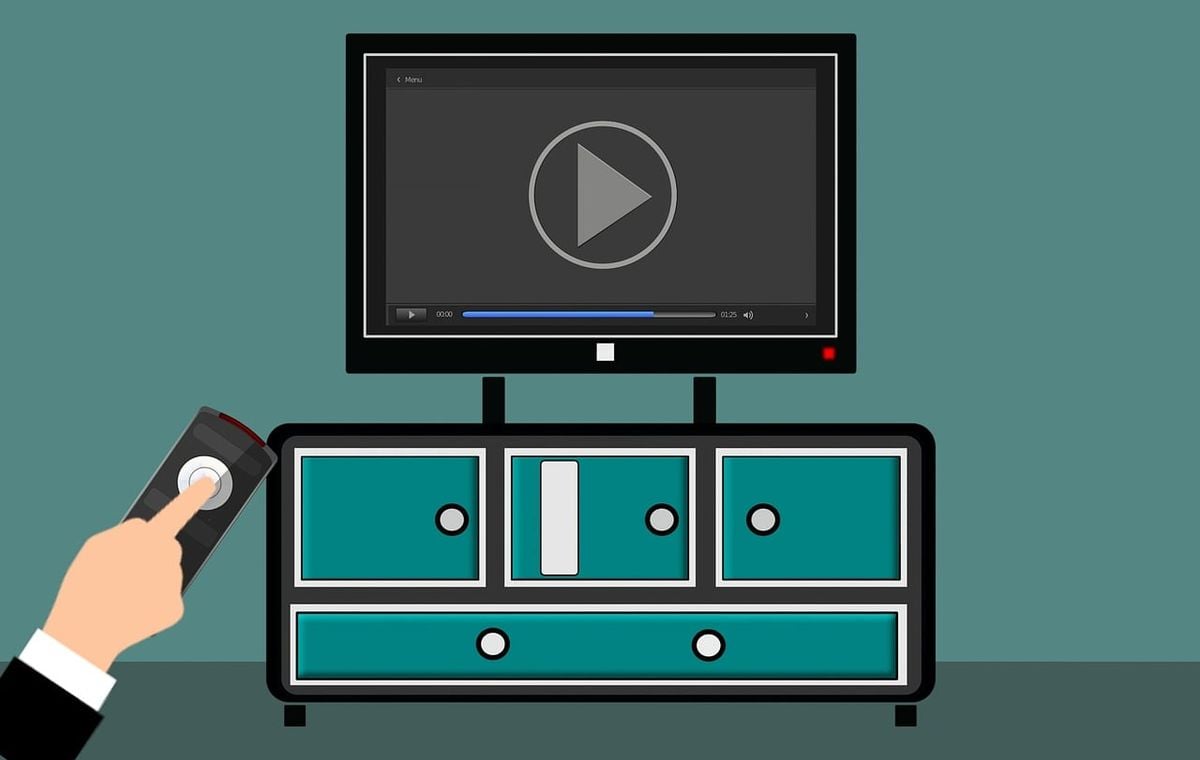Pessoa apontando o controle remoto para uma TV exibindo interface de streaming