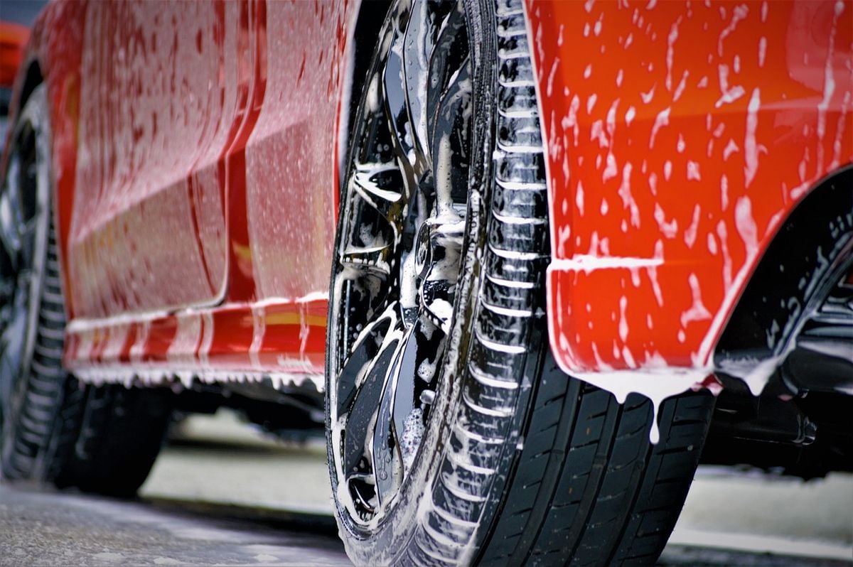 Roda de carro coberta de espuma durante a lavagem